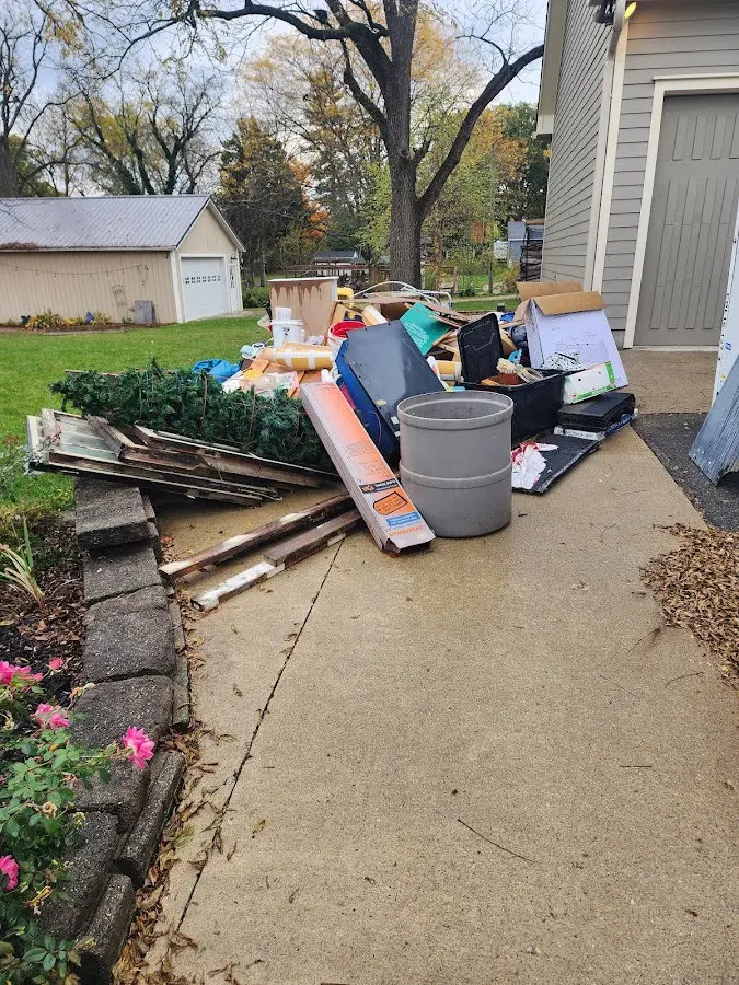 Dumpster being loaded with debris for 10 Yard Dumpster Rental in Rexburg